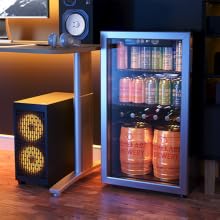 A Beverage Cooler placed Beside a Computer Table in a Gaming Room